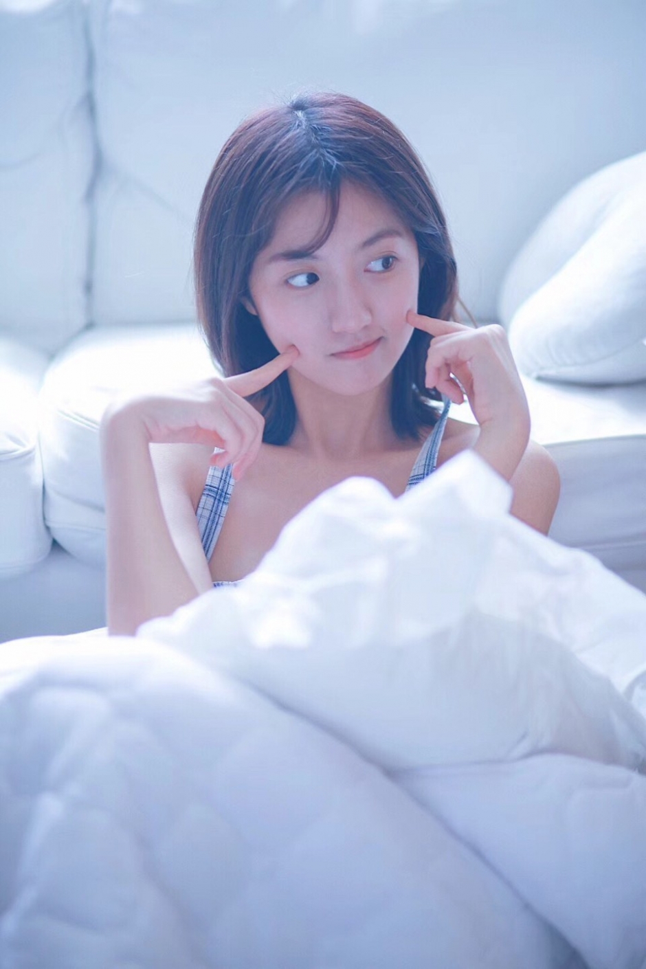 床上美女吊带睡衣白嫩肌肤露齿甜笑图片